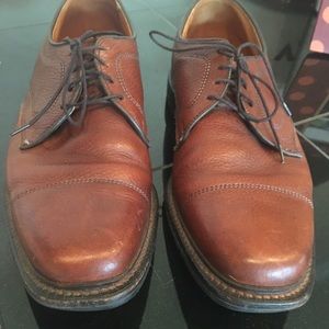 Allen Edmonds brown leather shoes.